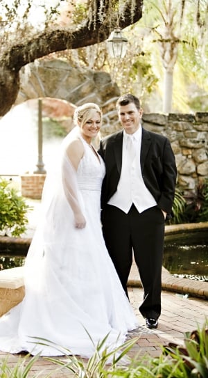 groom and bride standing brown under tree during daytime thumbnail