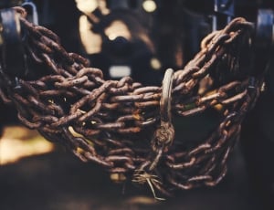 rusted metal chains tied in black metal bar thumbnail