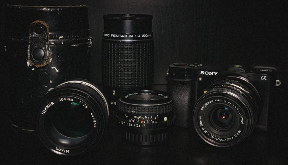 sony dslr camera and three black lens preview
