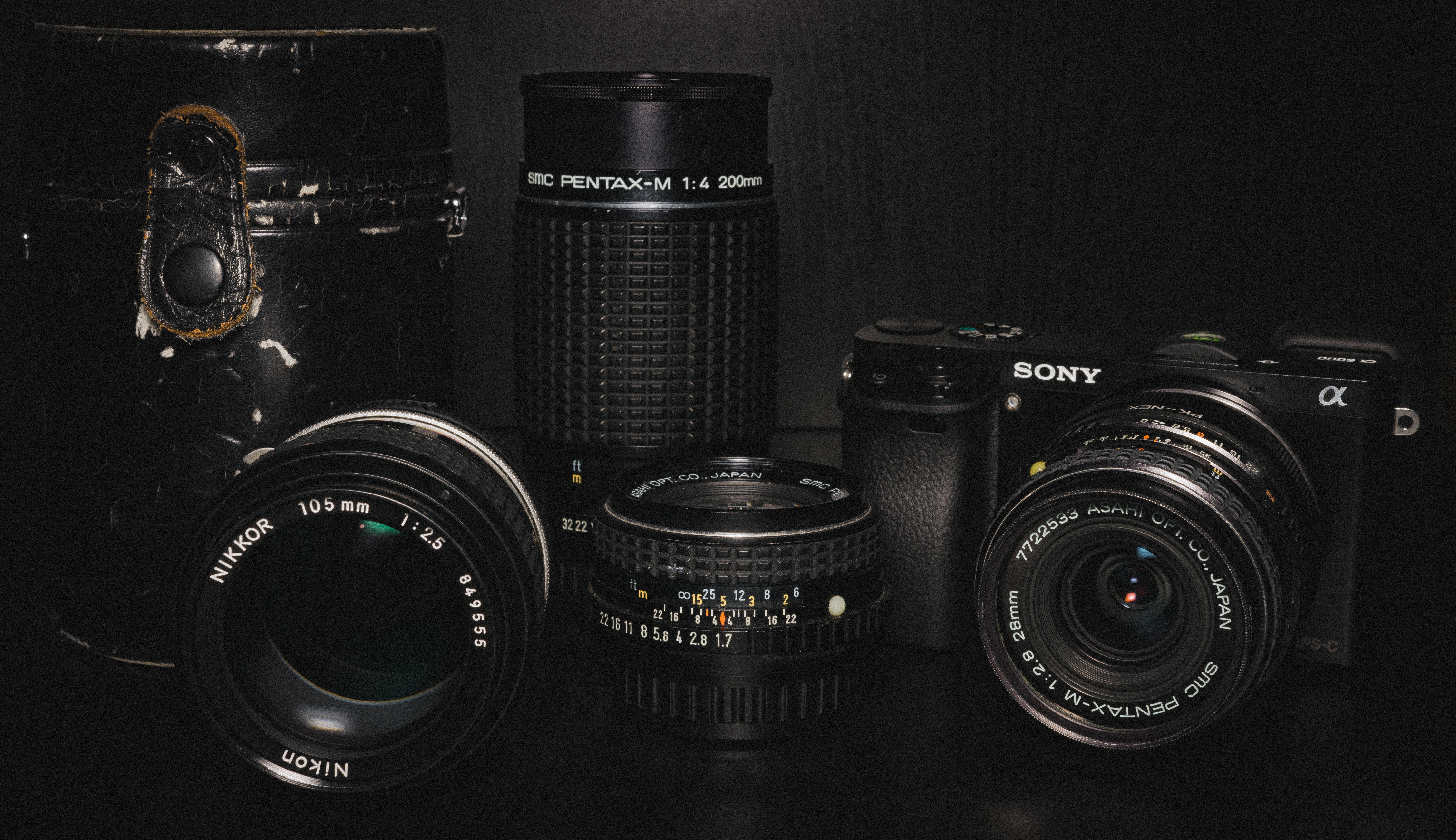 sony dslr camera and three black lens