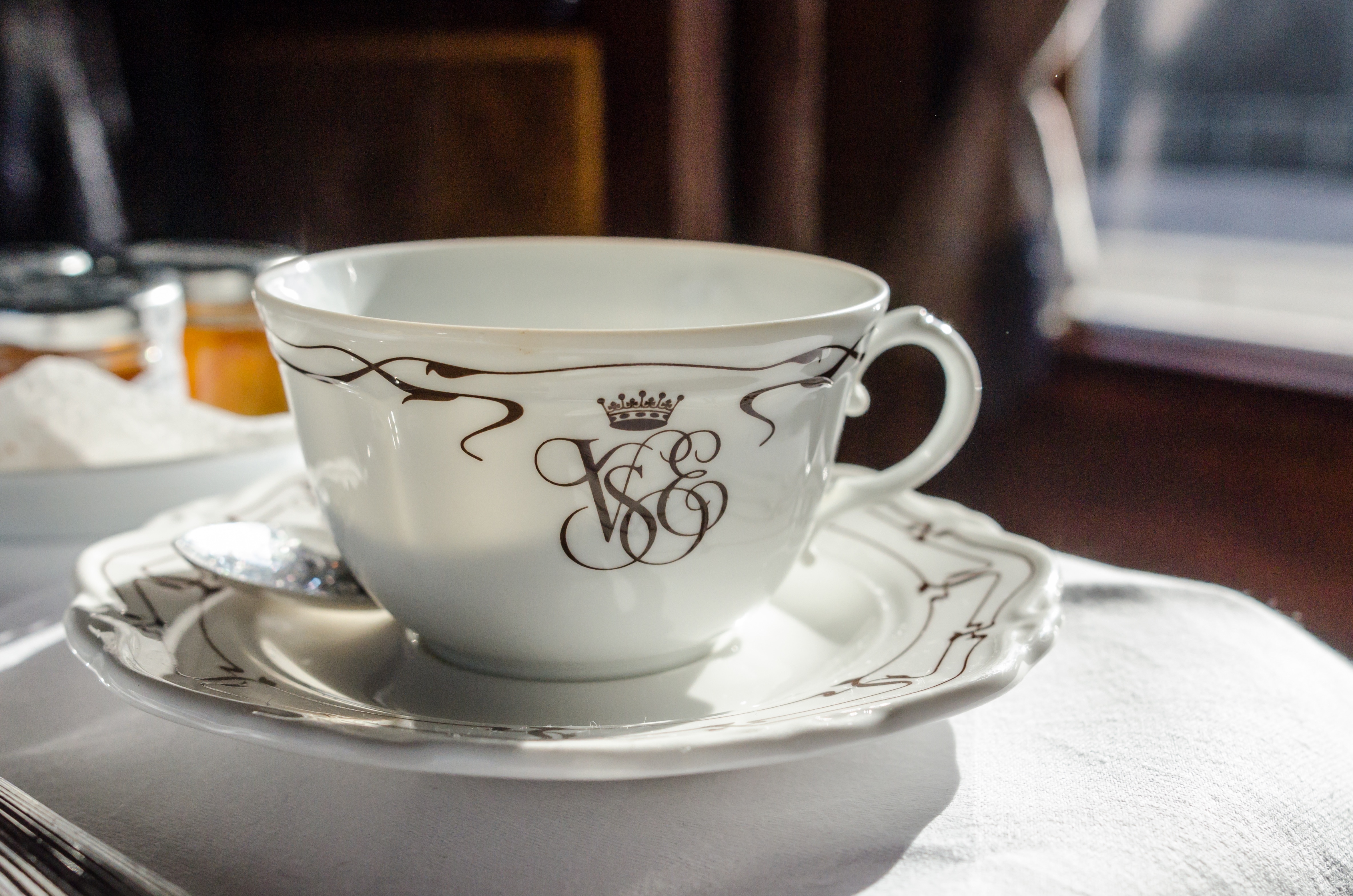 white and brown ceramic teacup