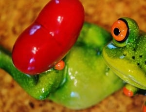 green and red ceramic frog figurine thumbnail