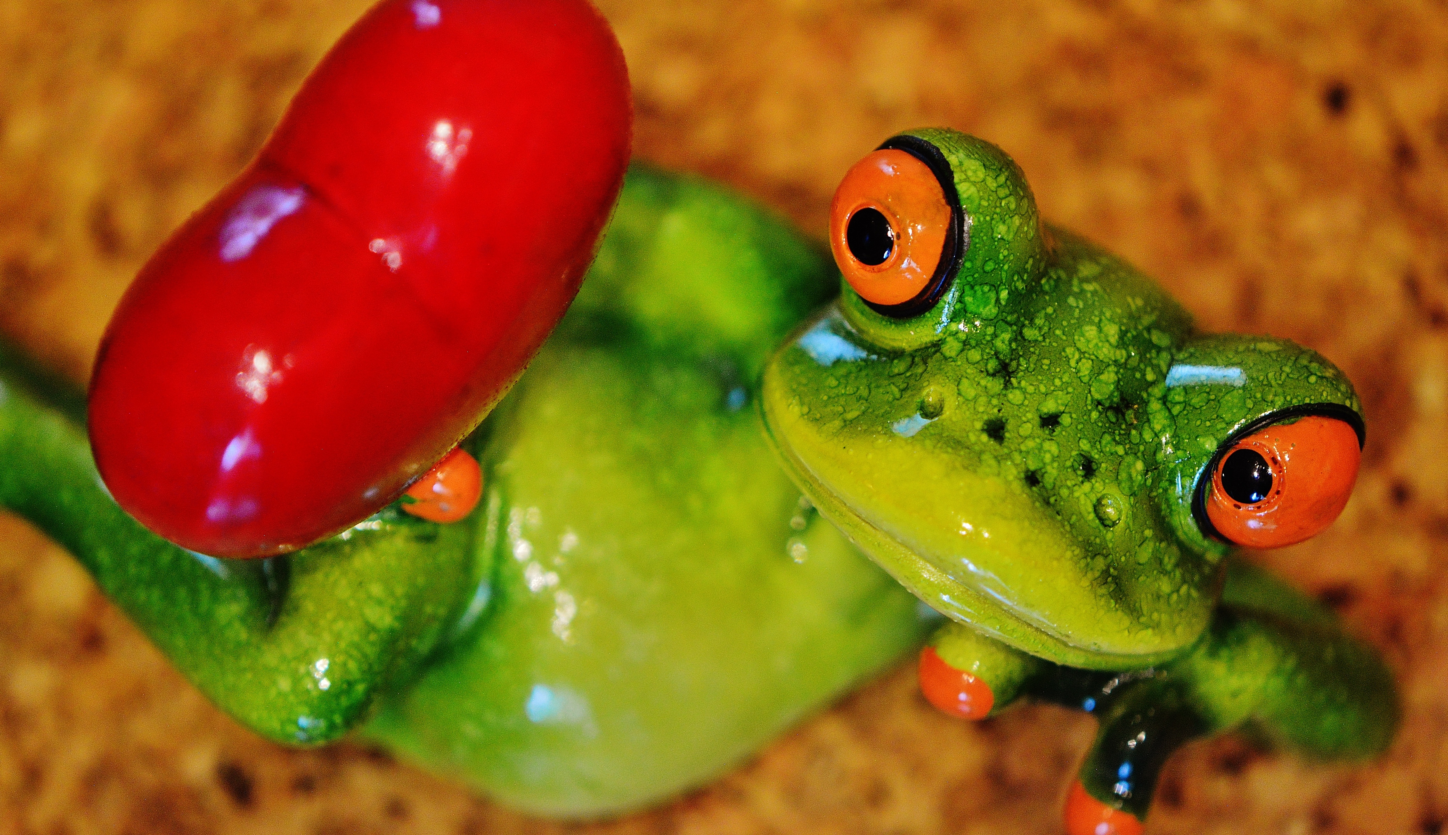 green and red ceramic frog figurine