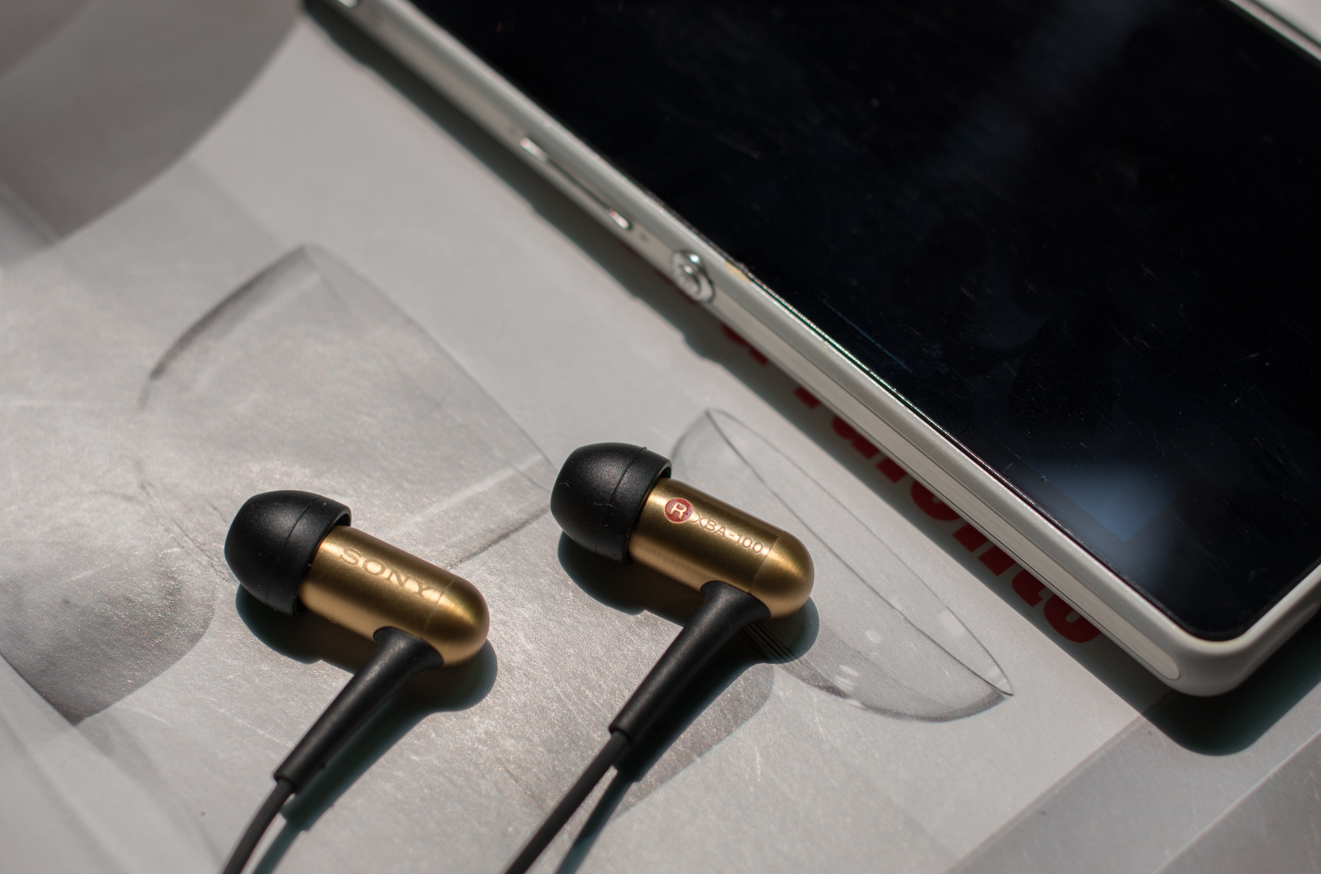 brown and black sony earbuds
