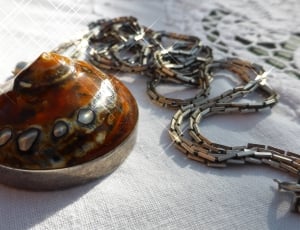 brown and silver round pendant thumbnail