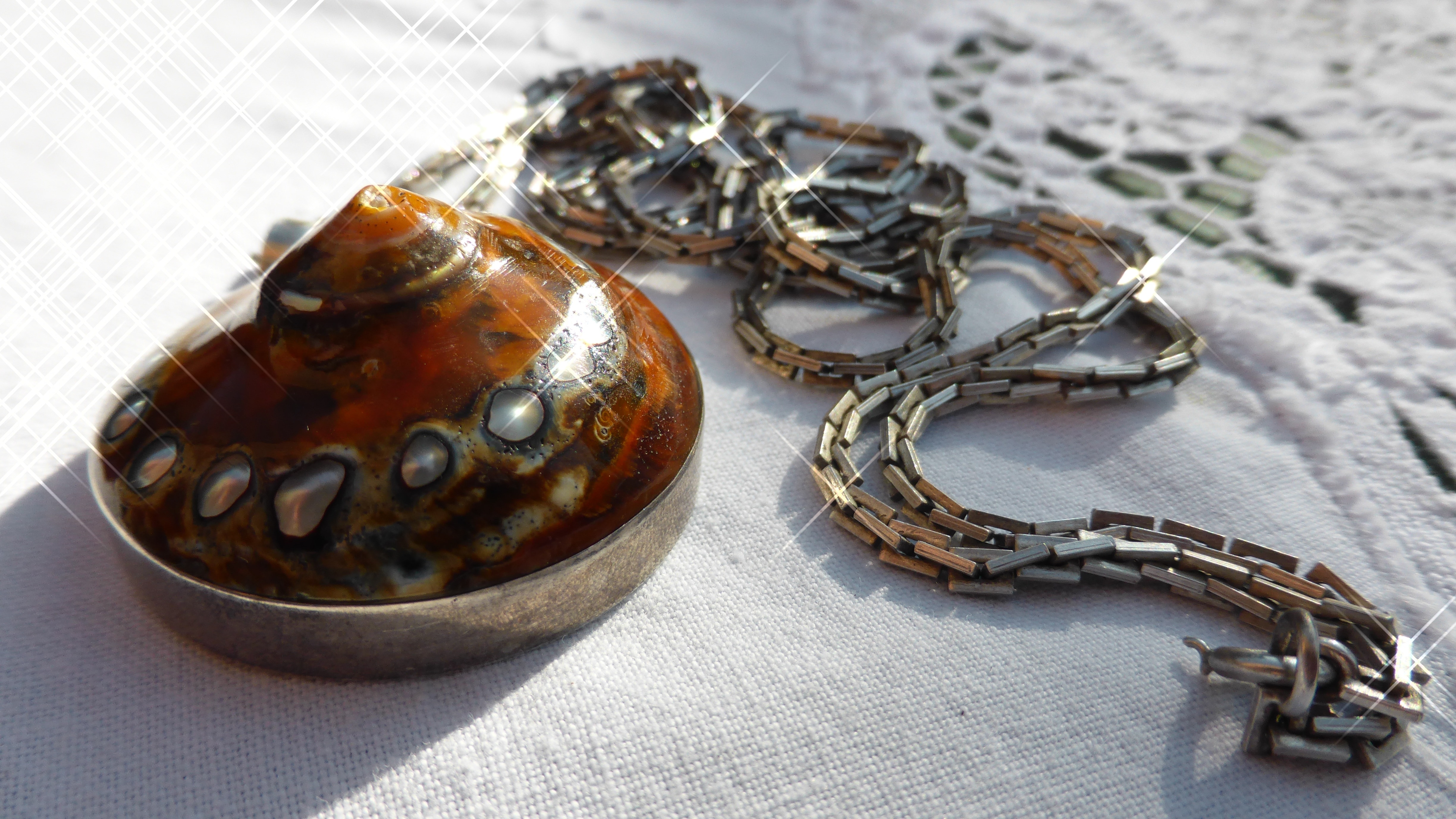 brown and silver round pendant