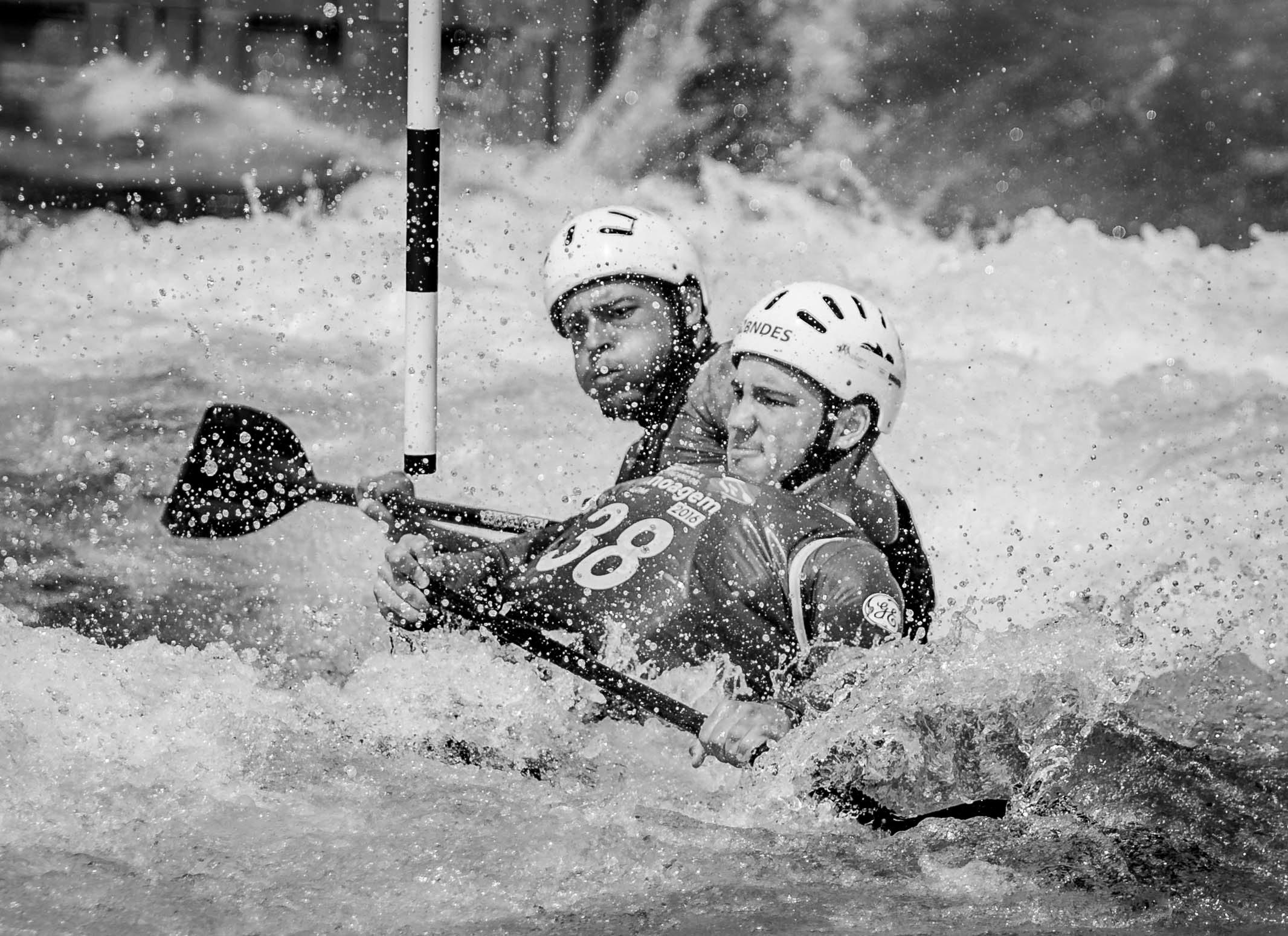 man water rafting in grayscale photo