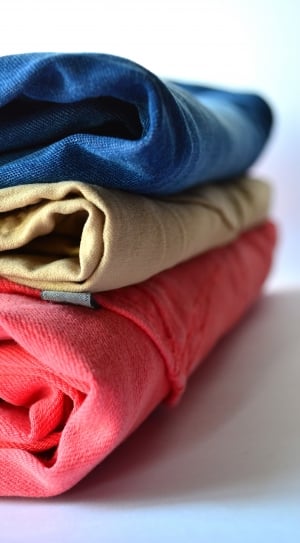 stack of blue, brown and pink textiles thumbnail
