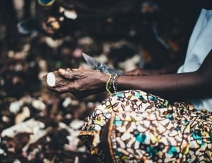 person holding knife and cassava thumbnail