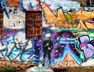 purple, blue, white, and black Graffiti painted wall thumbnail