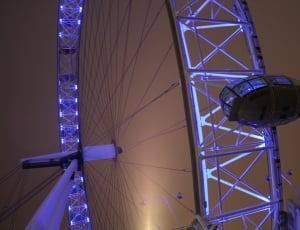 low angle view of white lighted ferris wheel thumbnail