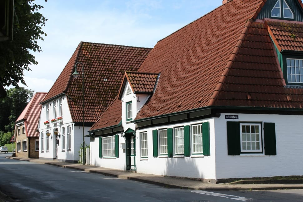 white paint town houses with brown roofs preview