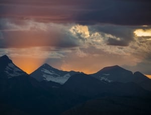 snow covered mountains during golden hour thumbnail