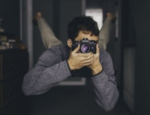 man floating white taking photo in selective focus photography thumbnail