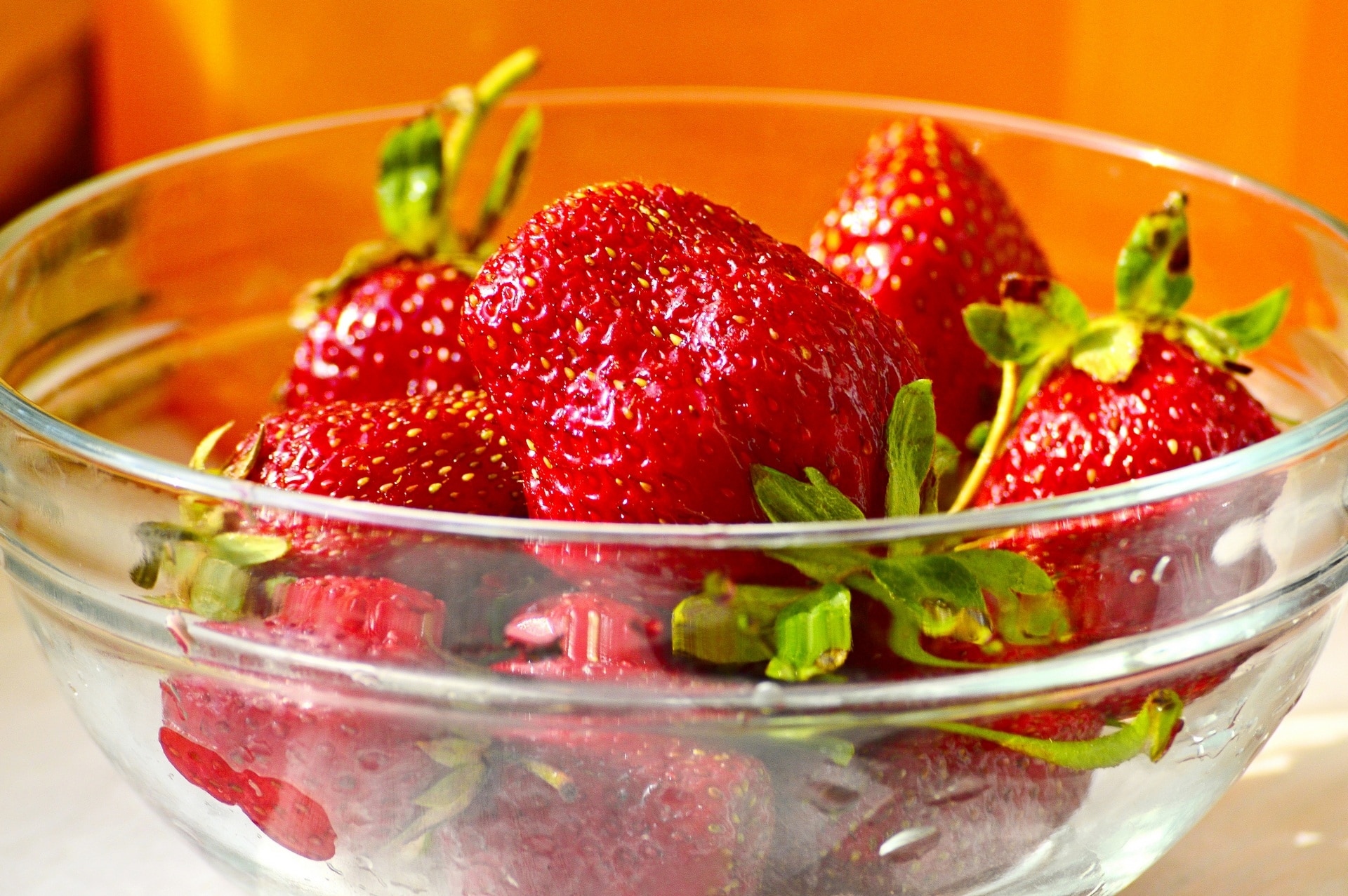 red strawberries in glass bowl