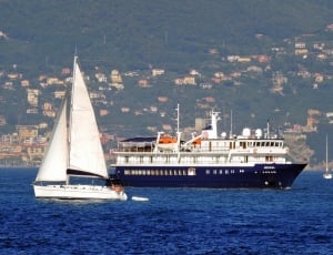 white blue cruise ship and sail boat thumbnail