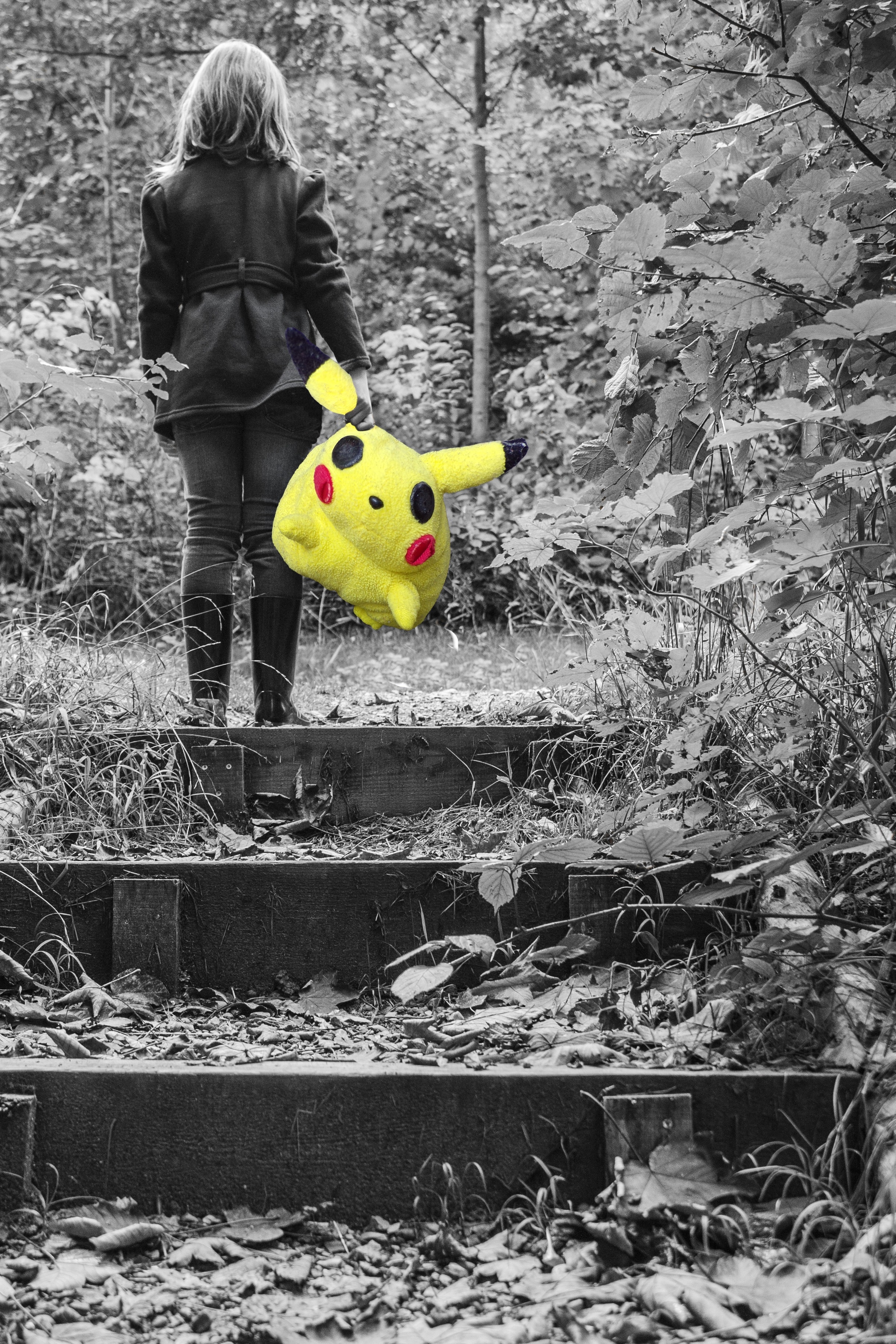 person carrying pikachu plush toy