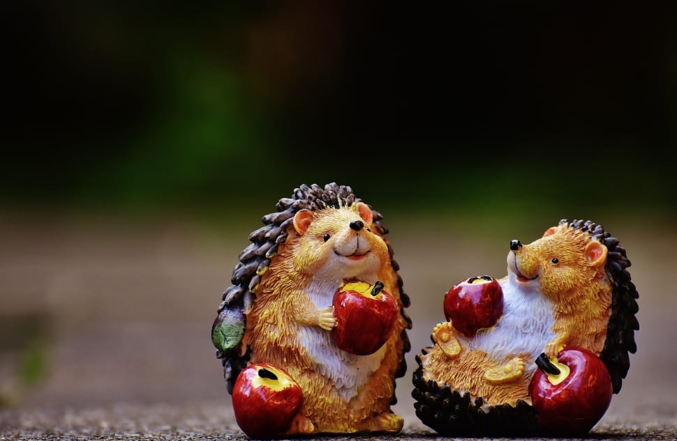 2 brown and black hedgehog with apple fruit figurine preview