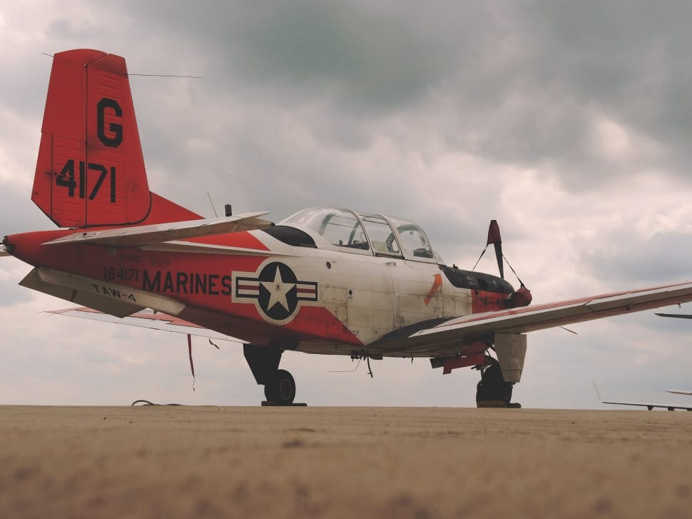 photograph of red and white airplane preview