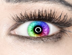 close up photo of person wearing multi-colored contact lens thumbnail