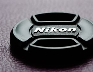 Nikon lens cover on grey surface thumbnail