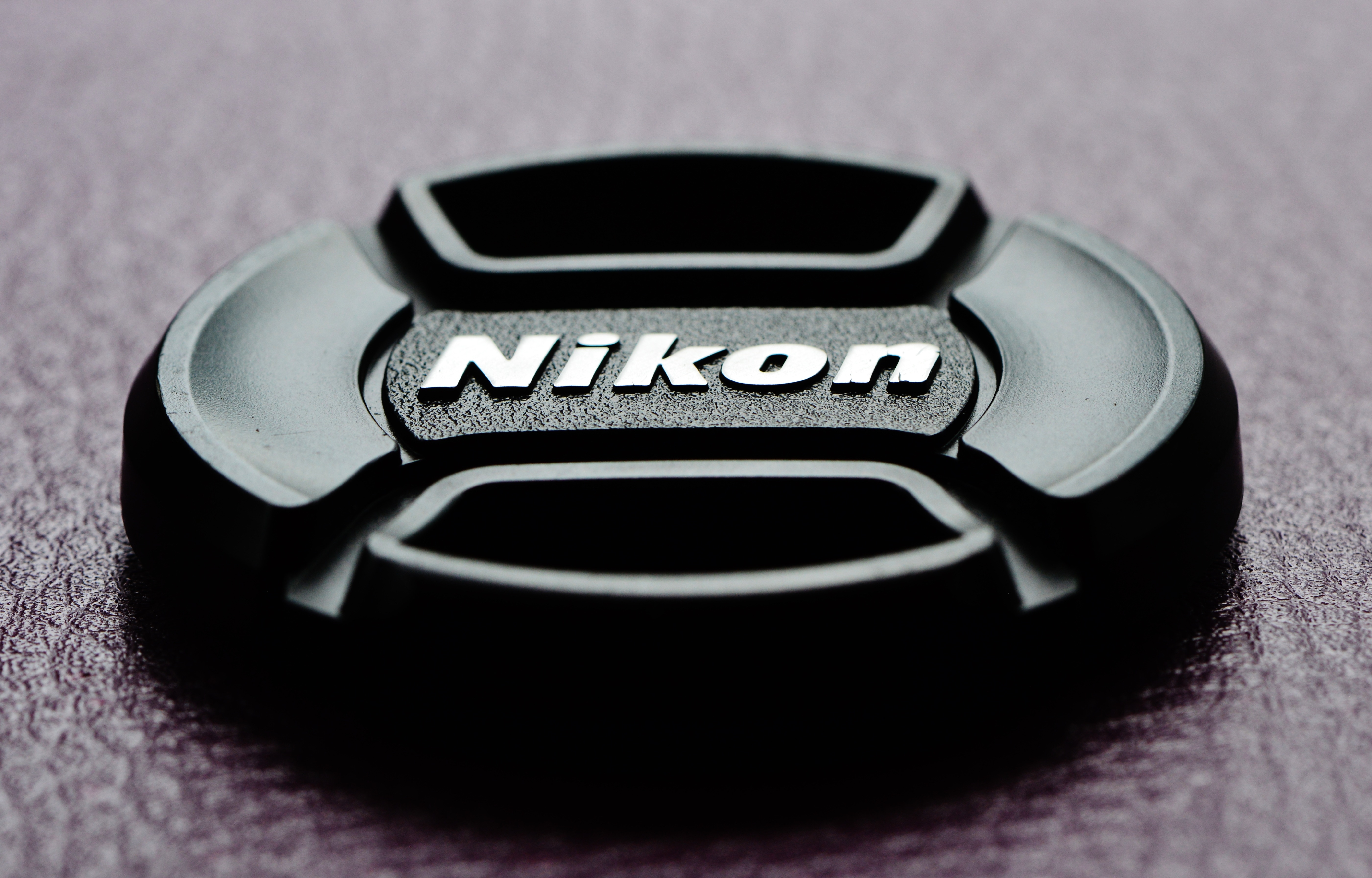 Nikon lens cover on grey surface