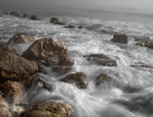 time lapse photography of sea wave and rocks thumbnail