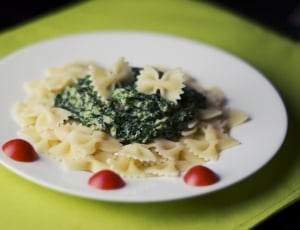 pasta with green toppings served on white ceramic plate thumbnail