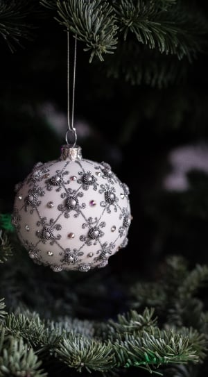 white and gray christmas baubles hanged on green tree thumbnail