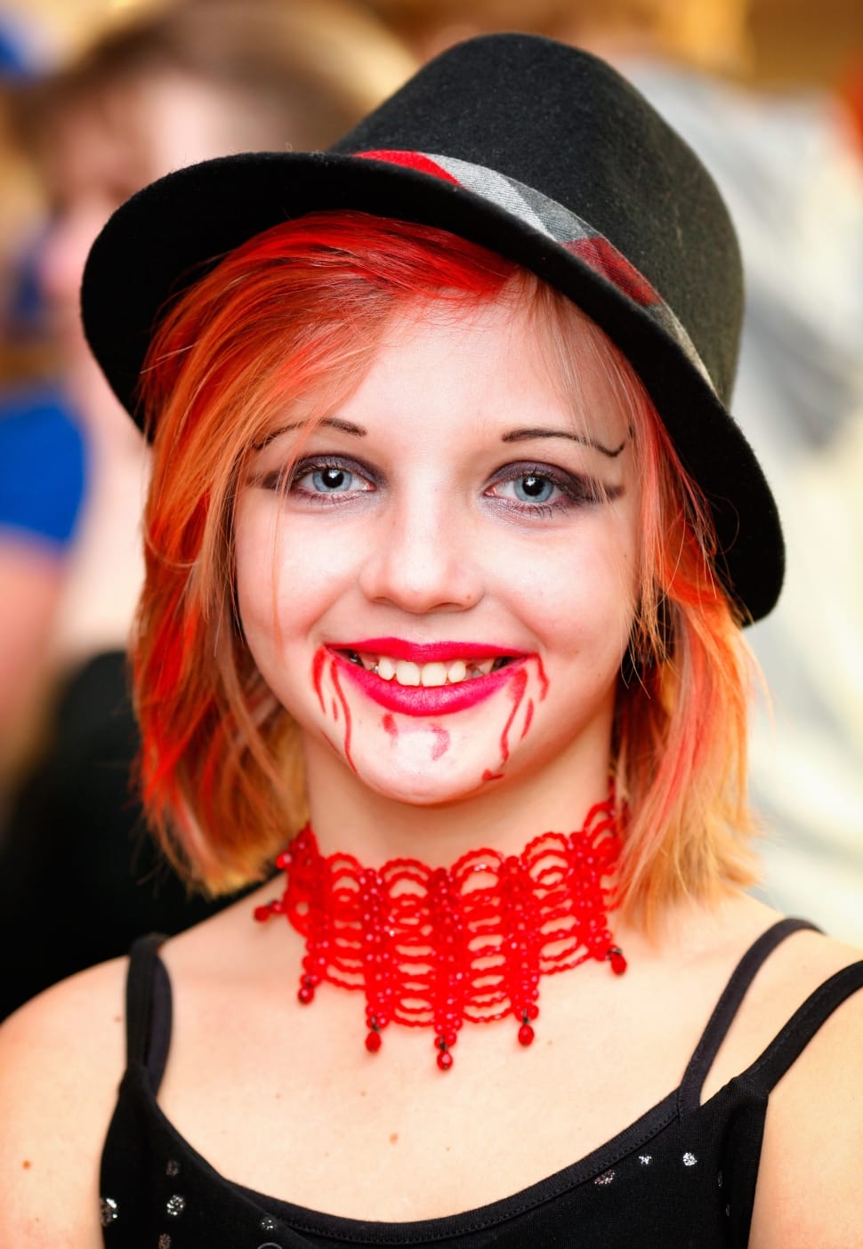 woman wearing black hat and red choker during daytime preview