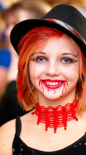 woman wearing black hat and red choker during daytime thumbnail