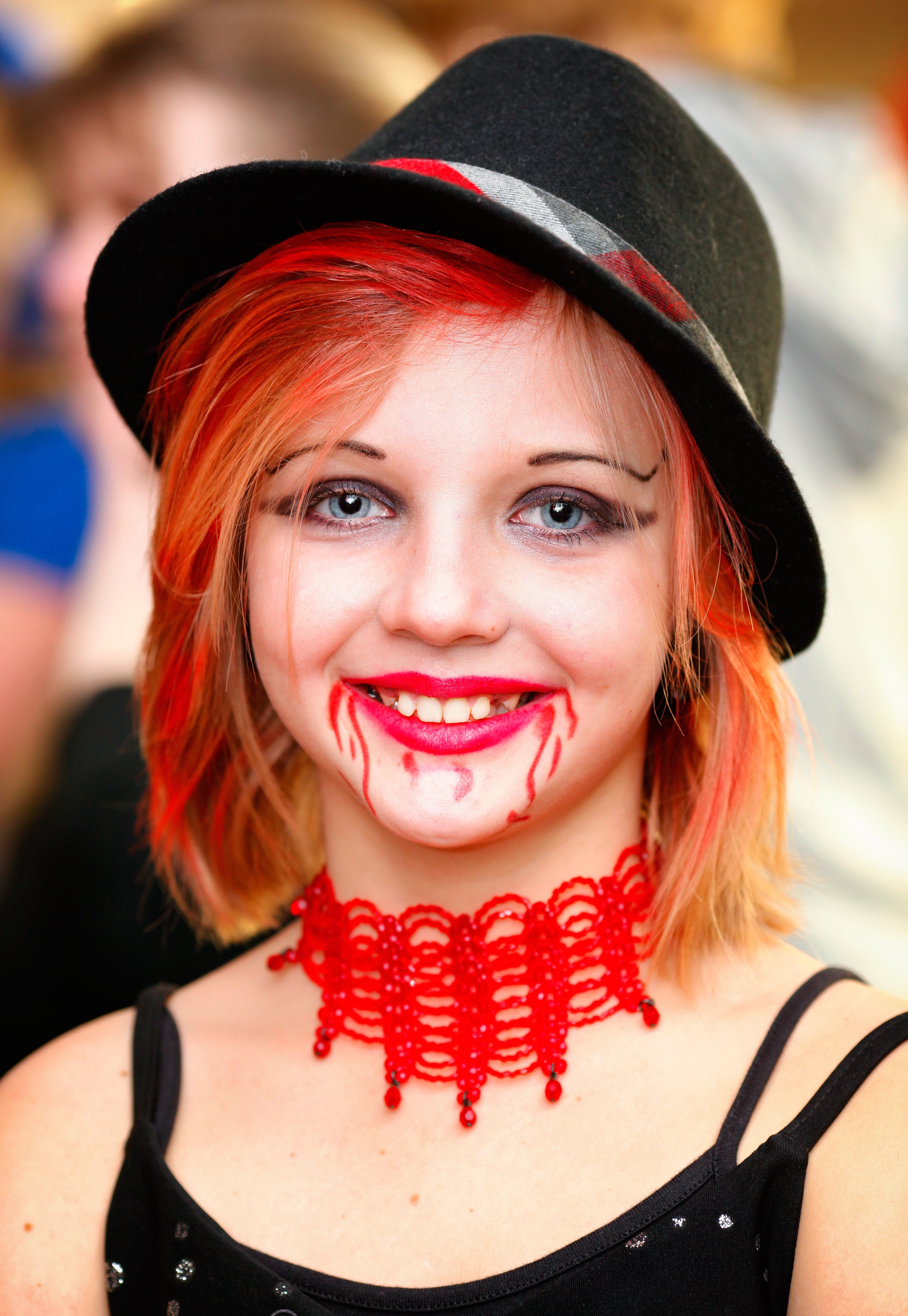 woman wearing black hat and red choker during daytime