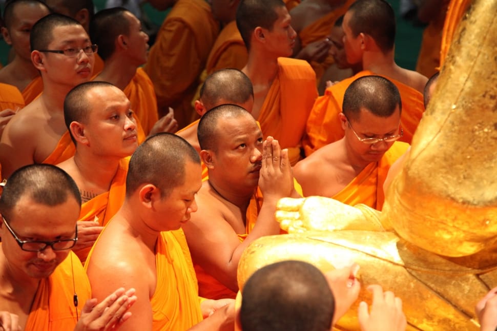praying monks in front of statue preview