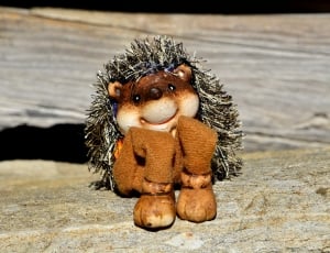 hedgehog plush toy on wooden surface thumbnail