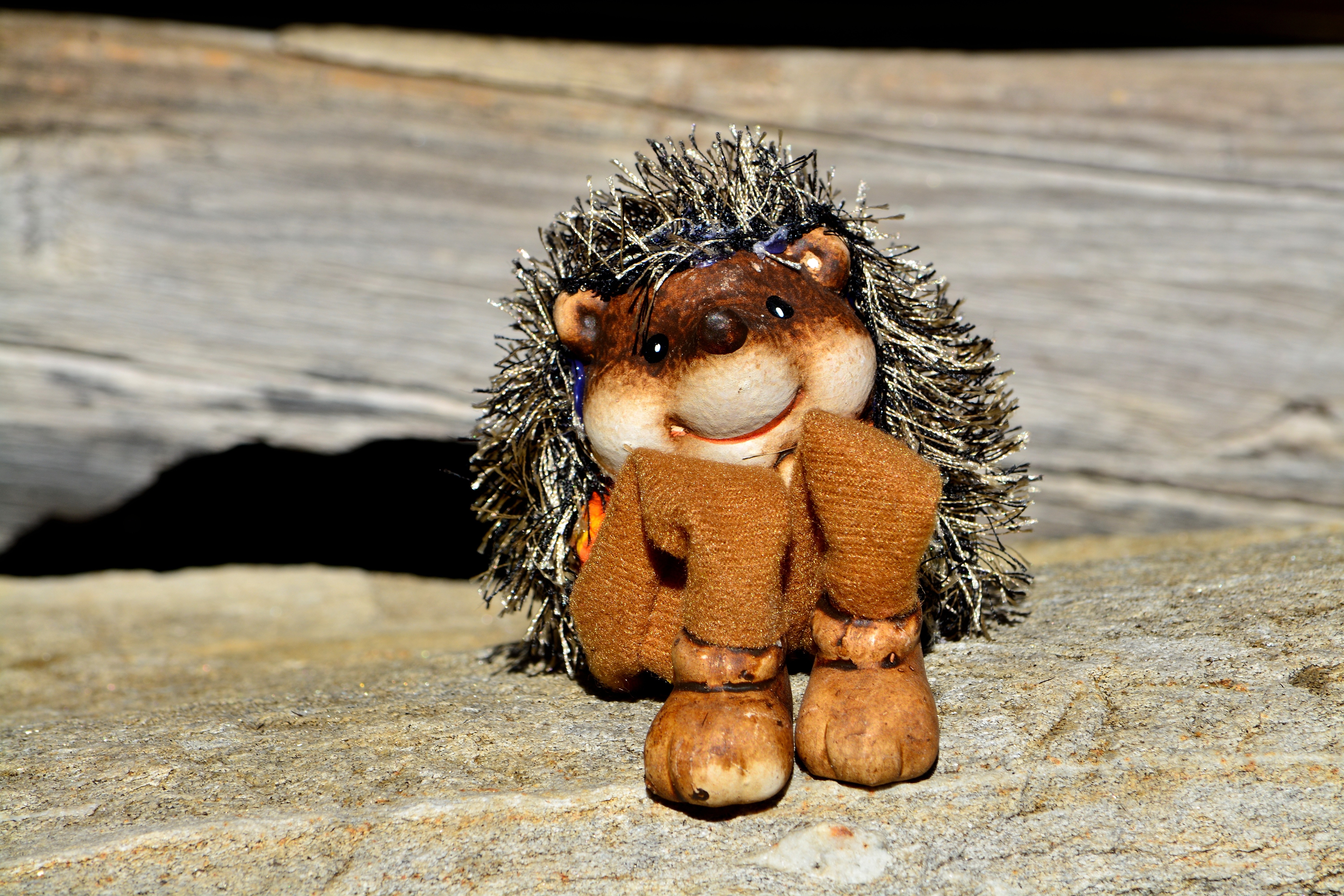 hedgehog plush toy on wooden surface