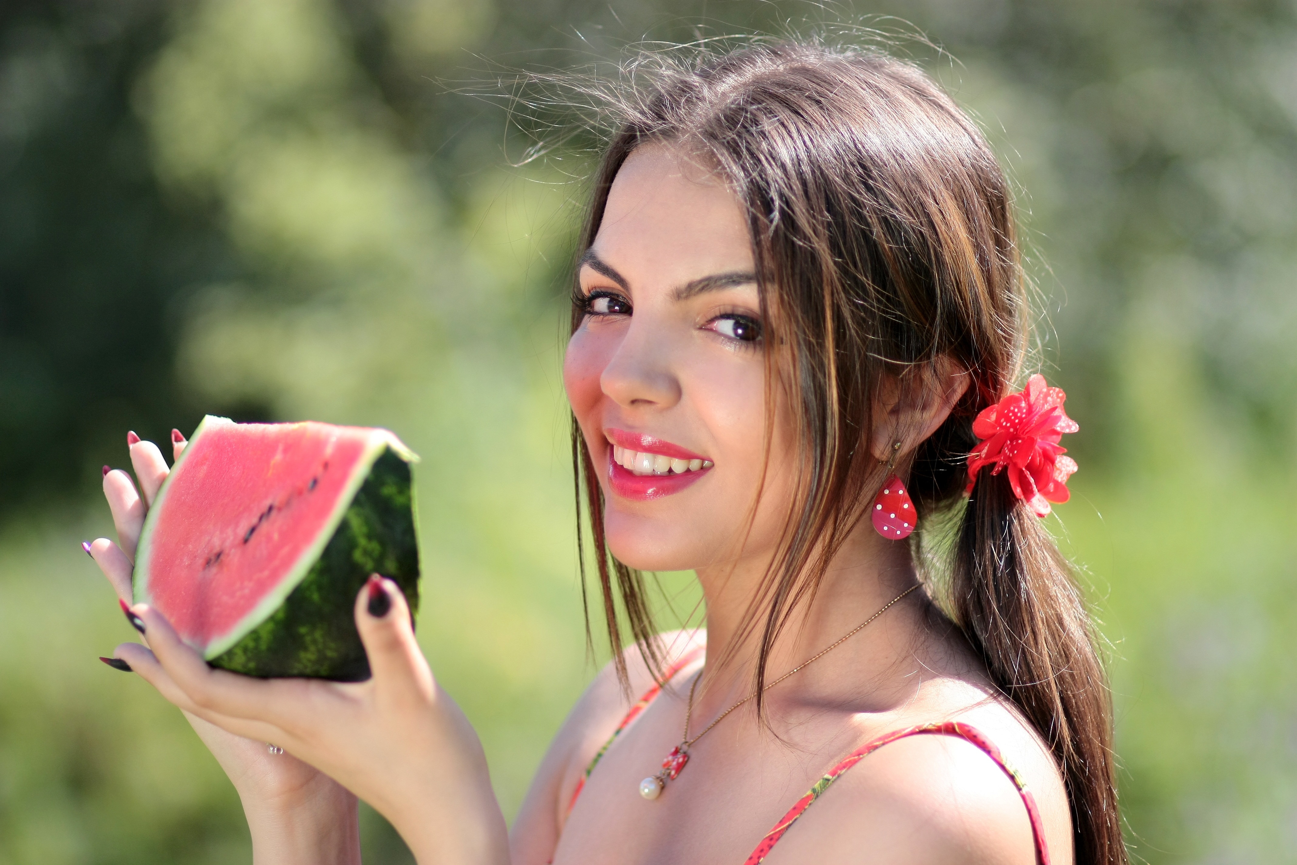 Customize wallpaper resolution. tilt shift photo of woman holding slice of watermelon...