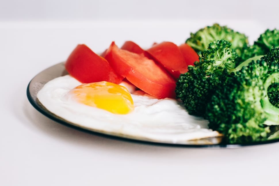 egg four slices of tomato and broccoli on glass plate preview