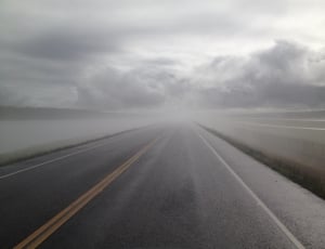 asphalt road under cloudy sky thumbnail