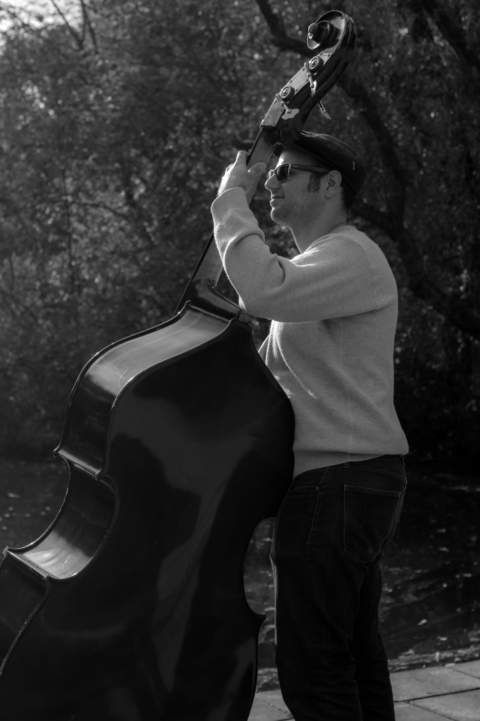 gray scale photography of man playing cello preview