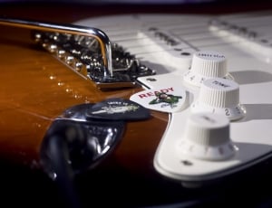 brown and white stratocaster guitar thumbnail