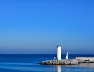 photo of white tower on body of water thumbnail