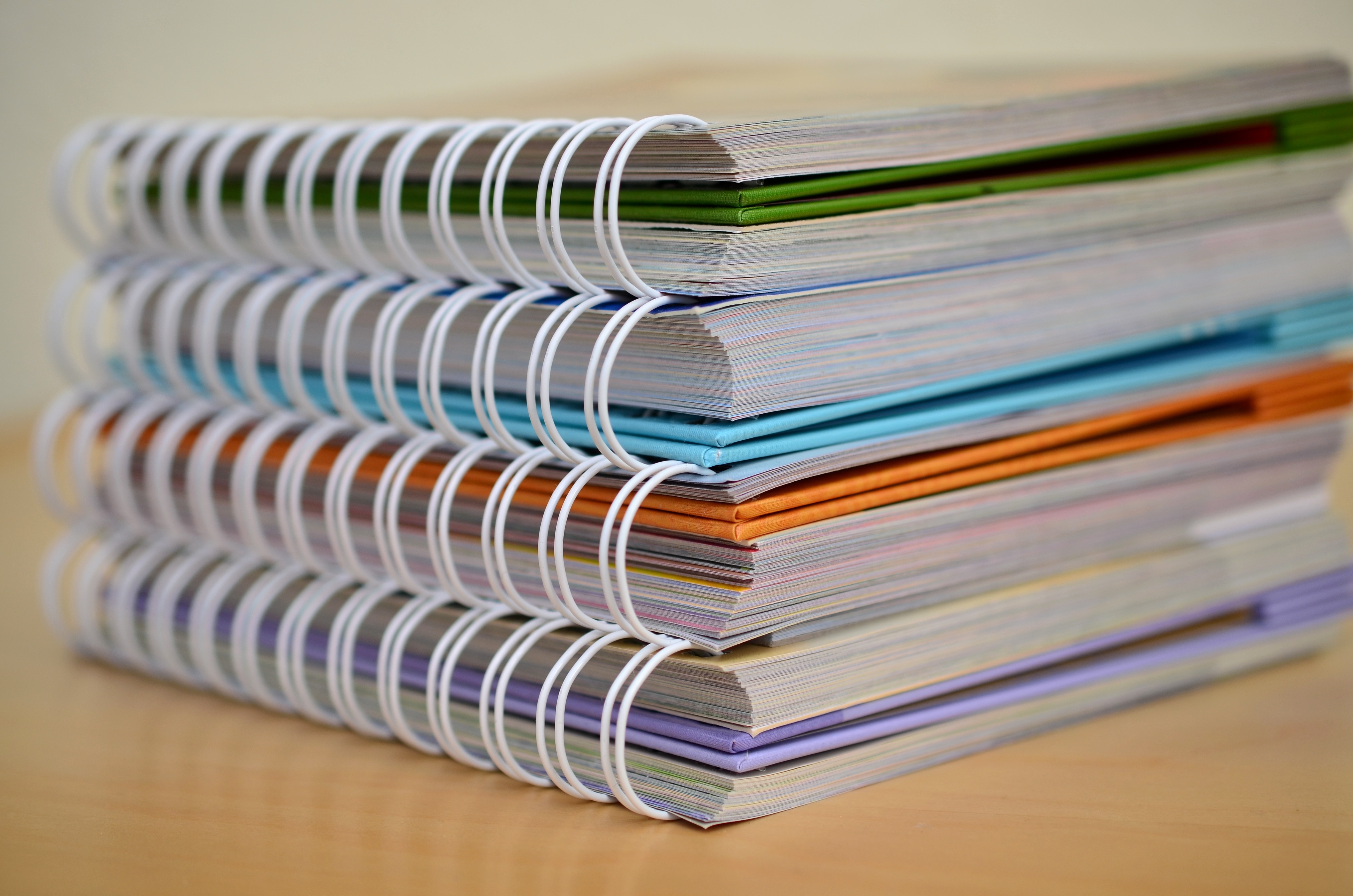 close up photo of four spiral notebooks