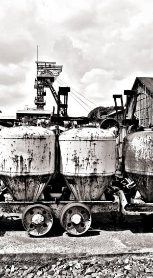 grayscale photo of tanks with wheels thumbnail