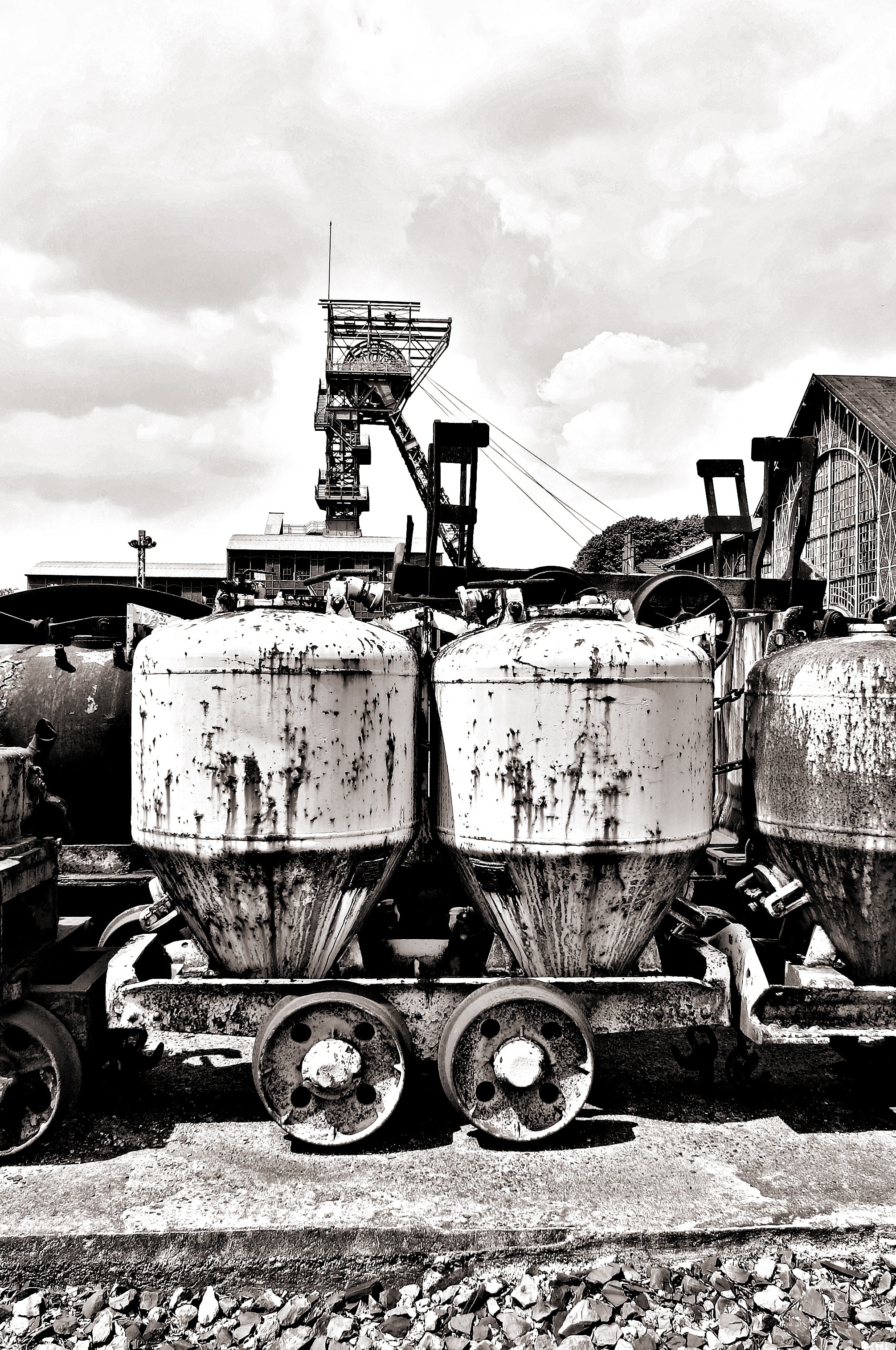 grayscale photo of tanks with wheels