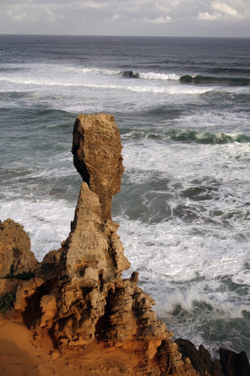 rock formation near waving seashore preview