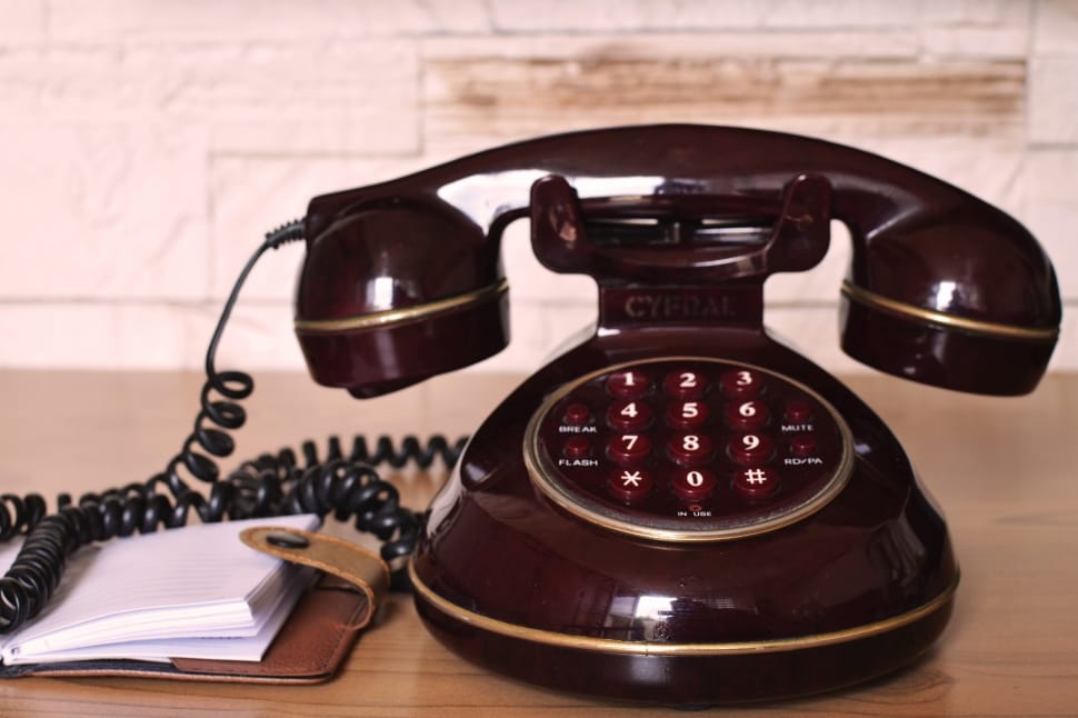 close up photo of brown cradle telephone preview