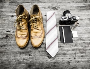 brown leather dress shoes necktie and camera thumbnail