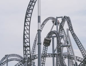 gray roller coasters under gray sky thumbnail
