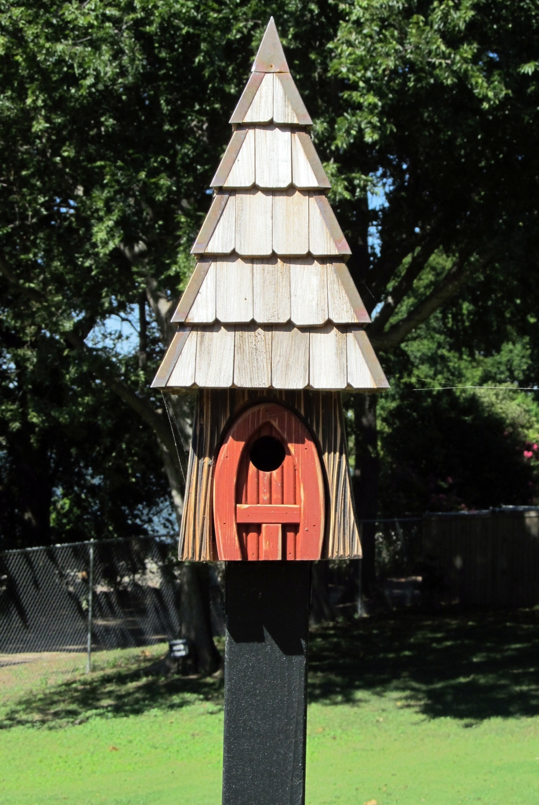 gray and orange wooden bird house