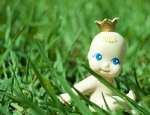 white baby toy on green grass during daytime thumbnail